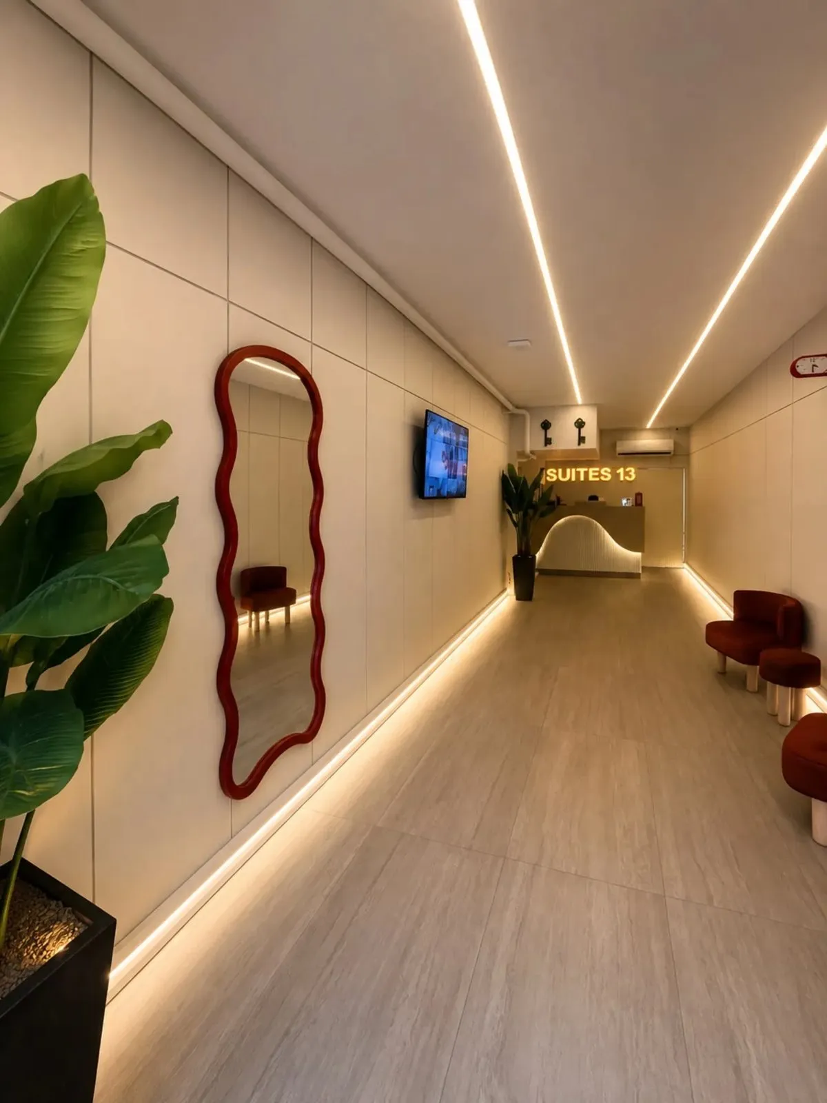 A lit hotel corridor with a mirror